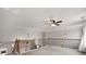 Inviting loft space with decorative railing and a ceiling fan at 320 Roland Manor Dr, Dacula, GA 30019
