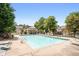 Community pool with many lounge chairs, clear blue water, and surrounding mature shade trees at 320 Roland Manor Dr, Dacula, GA 30019