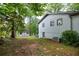 Spacious backyard featuring lush trees, with an air conditioning unit, and a storage shed at 5384 Blackhawk Dr, Acworth, GA 30102