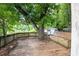 Backyard deck featuring a bench, tree, shed, and partially fenced yard at 3261 N Fulton Ave, Atlanta, GA 30354