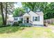 Cozy home with blue shutters and a small front porch framed by lush, green trees at 3261 N Fulton Ave, Atlanta, GA 30354