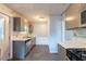 Kitchen featuring stainless steel appliances, tile floors, gray cabinets, and a glass tile backsplash at 3261 N Fulton Ave, Atlanta, GA 30354