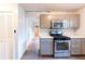 Kitchen featuring stainless steel appliances, gray cabinets, and tile backsplash at 3261 N Fulton Ave, Atlanta, GA 30354
