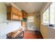 Laundry room features upper cabinets, a window, and a tiled floor at 3261 N Fulton Ave, Atlanta, GA 30354
