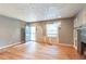 Spacious living room with hardwood floors, a brick fireplace, and large windows at 3261 N Fulton Ave, Atlanta, GA 30354