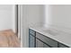 Bathroom vanity with gray cabinets, white countertops, and hardwood floors leading into the room at 370 Chicopee Dr, Marietta, GA 30064