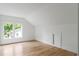 Slanted ceiling bedroom with a hardwood floor and bright light from the outdoor windows at 370 Chicopee Dr, Marietta, GA 30064