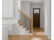 Bright entryway featuring hardwood floors, stairs with iron spindles, and a wood front door with glass panes at 370 Chicopee Dr, Marietta, GA 30064