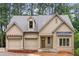 Charming, light beige, one-story home with a two car garage, covered front porch, and beautiful architectural details at 370 Chicopee Dr, Marietta, GA 30064