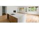 Kitchen island featuring quartz countertop, hardwood floors, and seamless flow into the living and dining areas at 370 Chicopee Dr, Marietta, GA 30064