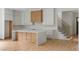 Modern kitchen featuring a quartz island, custom cabinets, and a view of the staircase and front door at 370 Chicopee Dr, Marietta, GA 30064