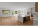 Sunlit living room with hardwood floors, large windows, and kitchen island, offering seamless indoor-outdoor living at 370 Chicopee Dr, Marietta, GA 30064