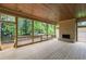 Inviting screened porch with a wood burning fireplace, wood plank flooring and views of the surrounding landscape at 370 Chicopee Dr, Marietta, GA 30064