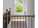 Staircase with wood railing and black iron balusters at 370 Chicopee Dr, Marietta, GA 30064