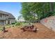 Backyard view of a home boasts a wood picnic table and retaining wall at 3765 Peachbluff Ct, Duluth, GA 30097
