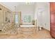 Luxurious bathroom featuring a soaking tub, glass shower, and tiled accents at 3765 Peachbluff Ct, Duluth, GA 30097