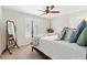 Calm bedroom features plush bedding, shutters, a ceiling fan and a full length mirror at 3765 Peachbluff Ct, Duluth, GA 30097