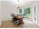 Bright breakfast nook featuring tile floors, large windows with backyard views, and an adjacent door to the backyard at 3765 Peachbluff Ct, Duluth, GA 30097