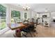 Bright breakfast nook with tile floors, large windows overlooking backyard, and an adjacent kitchen at 3765 Peachbluff Ct, Duluth, GA 30097