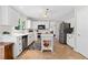 Bright kitchen features white cabinets, stainless steel appliances, and a functional center island at 3765 Peachbluff Ct, Duluth, GA 30097