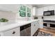 Charming kitchen with white cabinets, stainless steel appliances, and a view of lush greenery at 3765 Peachbluff Ct, Duluth, GA 30097