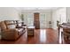 Inviting living room featuring hardwood floors, custom shutters, and ample seating at 3765 Peachbluff Ct, Duluth, GA 30097