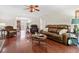 Spacious living room featuring hardwood floors, ample seating, and large windows at 3765 Peachbluff Ct, Duluth, GA 30097