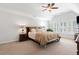 A spacious main bedroom featuring a ceiling fan, large windows, and neutral color palette at 3765 Peachbluff Ct, Duluth, GA 30097
