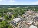 Expansive aerial view showcasing a town with varied architecture, lush greenery, and a charming community setting at 42 Riverdale St, Canton, GA 30114