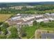 Expansive aerial view of commercial building with ample parking and lush green surroundings at 42 Riverdale St, Canton, GA 30114