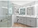 Bright bathroom featuring double vanity, a glass shower, and neutral tones for a relaxing atmosphere at 42 Riverdale St, Canton, GA 30114