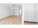 Light-filled bedroom featuring hardwood floors, a ceiling fan, large closet, and organized shelving at 42 Riverdale St, Canton, GA 30114
