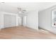 Bedroom with hardwood floors, large closet doors, and a ceiling fan with ample natural light at 42 Riverdale St, Canton, GA 30114