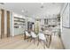 Open-concept dining area with modern table, wood columns, and an inviting kitchen view at 42 Riverdale St, Canton, GA 30114