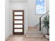 Modern entryway featuring a wood door with glass panels, stairs, and natural light at 42 Riverdale St, Canton, GA 30114