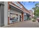 Charming brick building with awning, street bench, and sidewalk with 'OPEN' sign on the storefront at 42 Riverdale St, Canton, GA 30114
