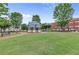 A public gazebo on a manicured lawn surrounded by trees and benches offers an inviting place to gather at 42 Riverdale St, Canton, GA 30114
