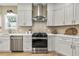 Modern kitchen featuring stainless steel appliances, white cabinetry, and hardwood floors at 42 Riverdale St, Canton, GA 30114
