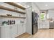 Stylish kitchen featuring a stainless steel refrigerator and open shelving at 42 Riverdale St, Canton, GA 30114