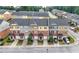 Aerial view of townhomes with multi-colored brick and siding, garages, and driveway at 771 Tulip Poplar Way, Lawrenceville, GA 30044