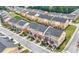 Aerial view of colorful townhomes in a well-maintained community with landscaped yards and private garages at 771 Tulip Poplar Way, Lawrenceville, GA 30044