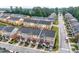 Aerial view of a residential neighborhood showcasing multi-colored townhomes with well-maintained landscaping at 771 Tulip Poplar Way, Lawrenceville, GA 30044
