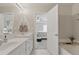 Bright bathroom featuring double sinks, tub, and doorway to the main bedroom at 771 Tulip Poplar Way, Lawrenceville, GA 30044