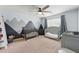 Neutral Bedroom showcasing a crib, changing table, dresser, and mountain mural with modern ceiling fan at 771 Tulip Poplar Way, Lawrenceville, GA 30044