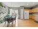 Bright open concept kitchen and dining space featuring hardwood floors, neutral walls, and backyard access at 771 Tulip Poplar Way, Lawrenceville, GA 30044