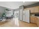 Open floor plan featuring hardwood floors, neutral walls, adjacent kitchen, and dining area with breakfast nook at 771 Tulip Poplar Way, Lawrenceville, GA 30044