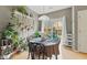 Charming dining area filled with plants, a round table, and sliding glass doors leading to the backyard at 771 Tulip Poplar Way, Lawrenceville, GA 30044