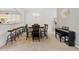 Spacious dining room featuring a large table, modern chandelier, adjacent kitchen with breakfast bar and a piano at 771 Tulip Poplar Way, Lawrenceville, GA 30044