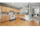 Bright kitchen features wood floors, countertops, tile backsplash, white appliances, and natural wood cabinets at 771 Tulip Poplar Way, Lawrenceville, GA 30044