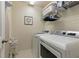 Practical laundry room with a side-by-side washer and dryer and functional shelving for storage at 771 Tulip Poplar Way, Lawrenceville, GA 30044